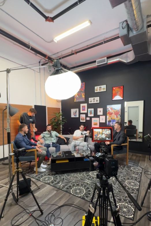Group podcast shoot with four guests on a couch